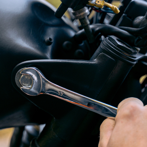 A wrench tightening a bolt.